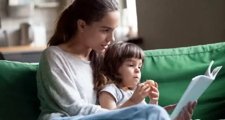 a babysitter reading to a child