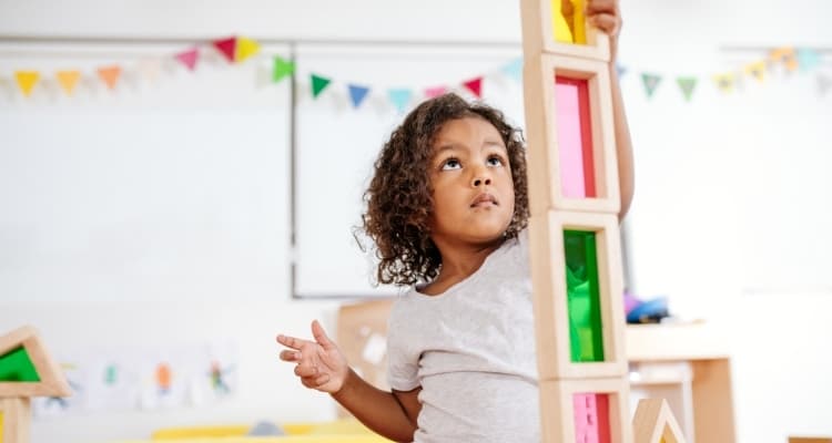 a young child playing with blocks