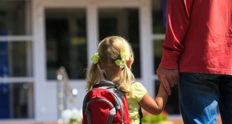 a parent taking a child to a house
