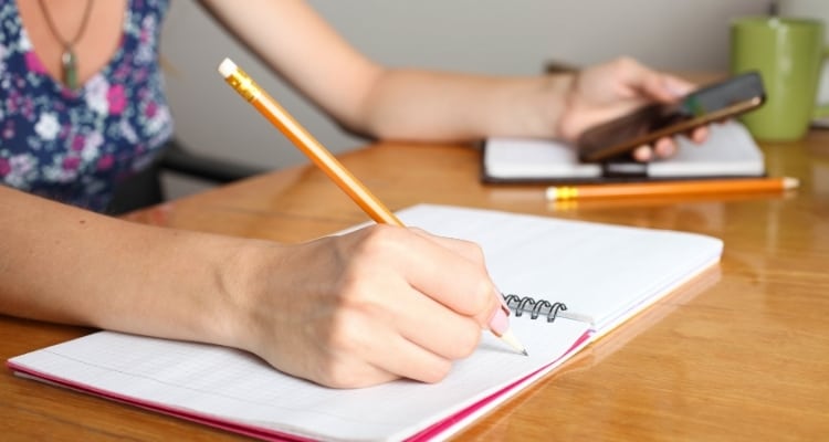 parent writing in a notebook