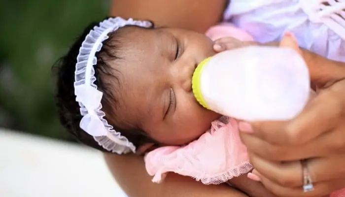 mom feeding newborn baby