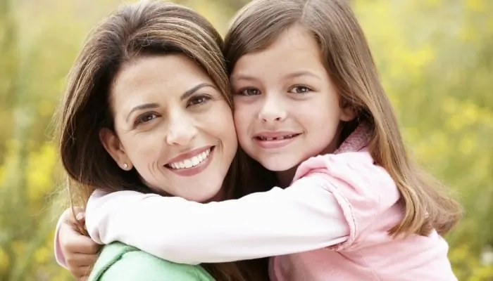 mom and daughter smiling