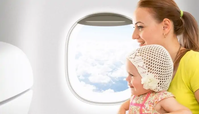 woman traveling with kid on airplane