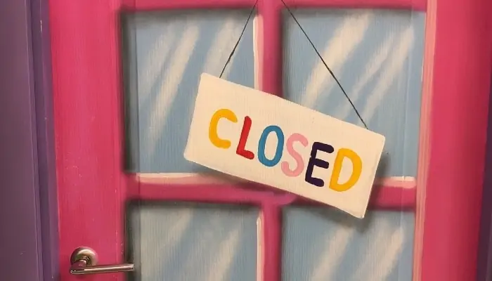 a closed sign hanging over a business