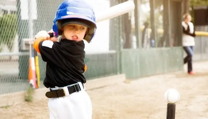 child swinging a bat