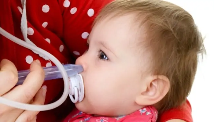 snot sucker being used on a child