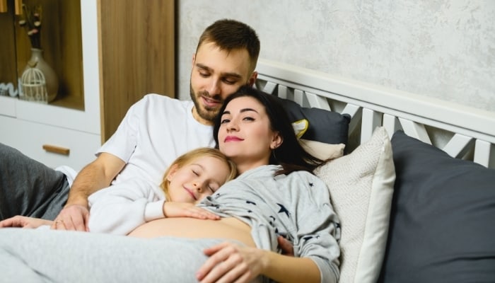child snuggling with parents