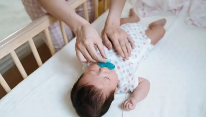 mom giving child pacifier