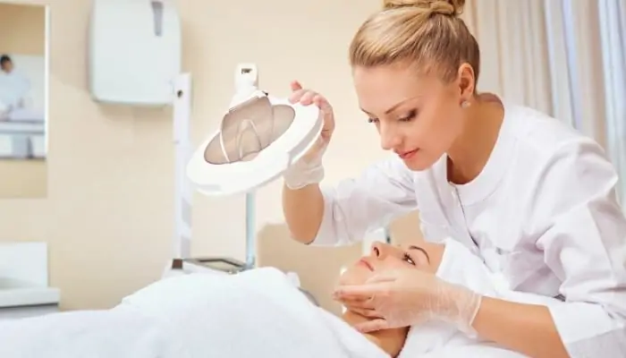 a cosmetologist with a patient