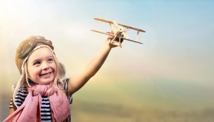 a kid holding a toy airplane