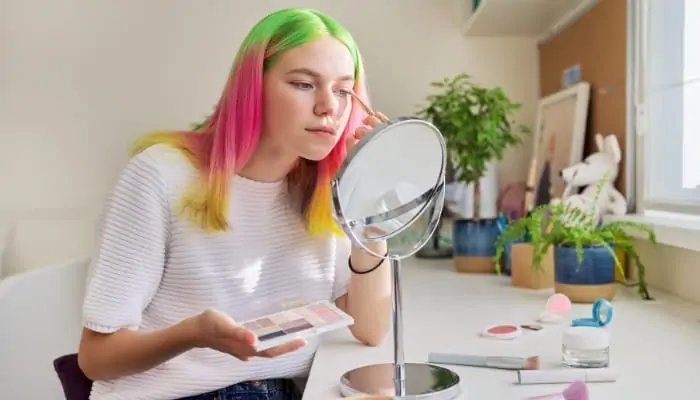 teenager with pink green yellow hair dyed