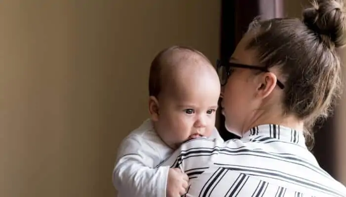 babysitter holding a new baby