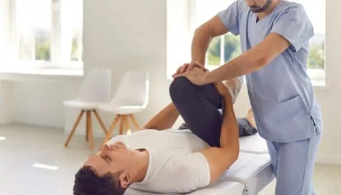 physical therapist helping a patient