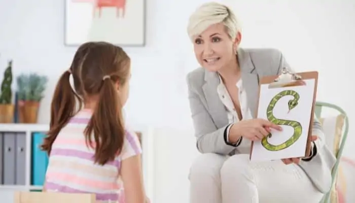 speech language pathologist working with patient