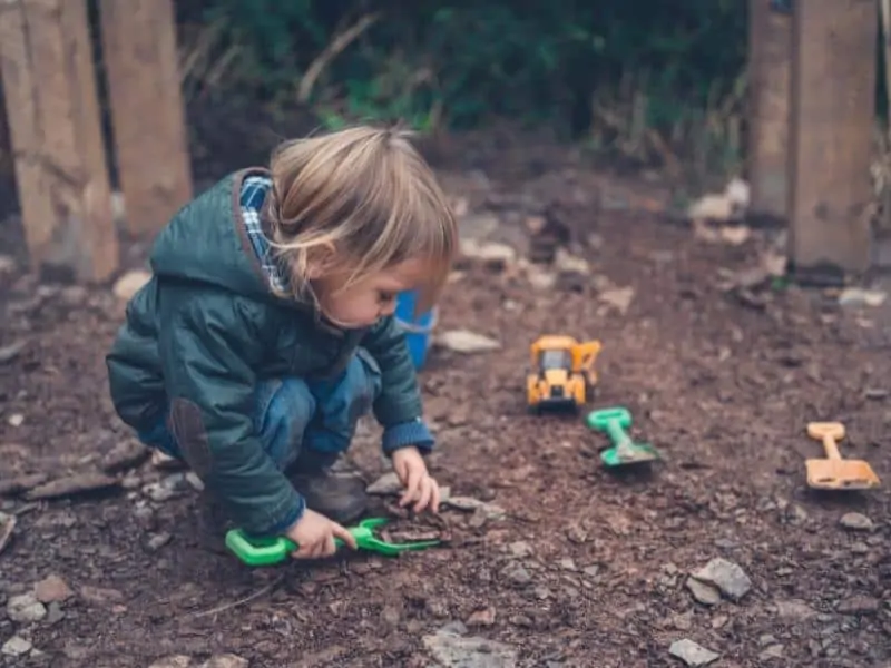 child playing in dirt