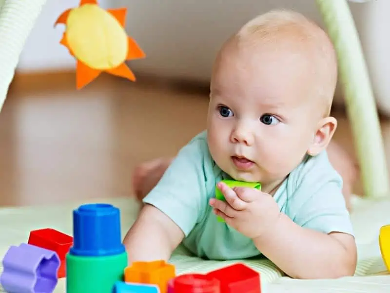 baby playing shape blocks