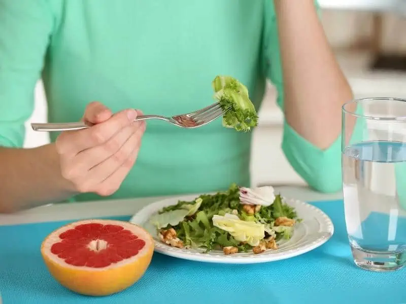 woman eating healthy food with water