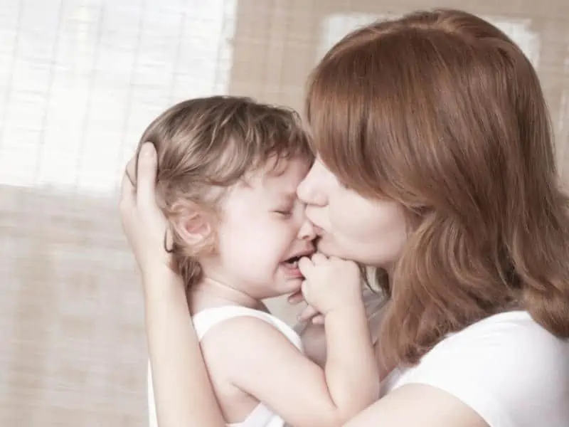 mother comforting crying child