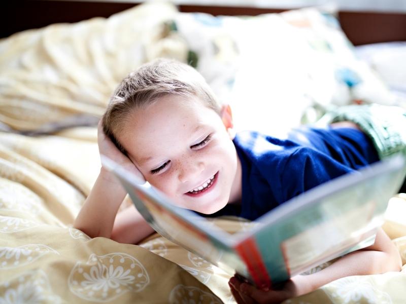 kid reading in bed