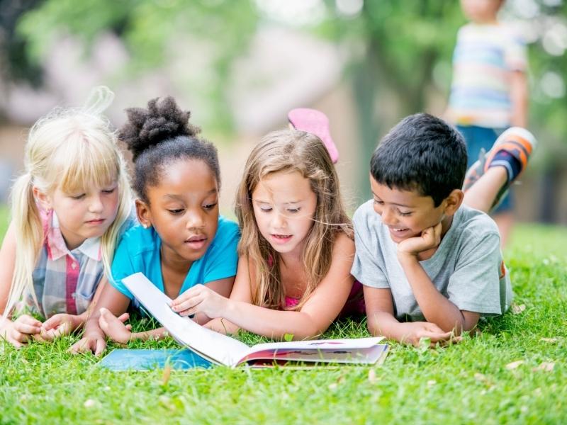 kids reading a book together