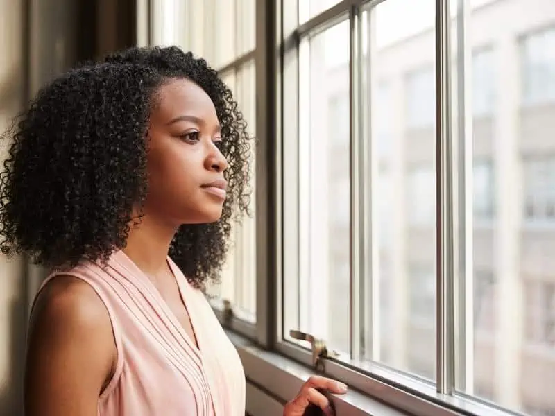 Article image - woman looking in window