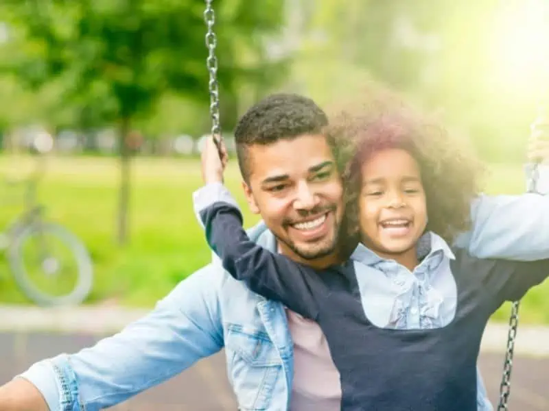 dad and daughter on swing