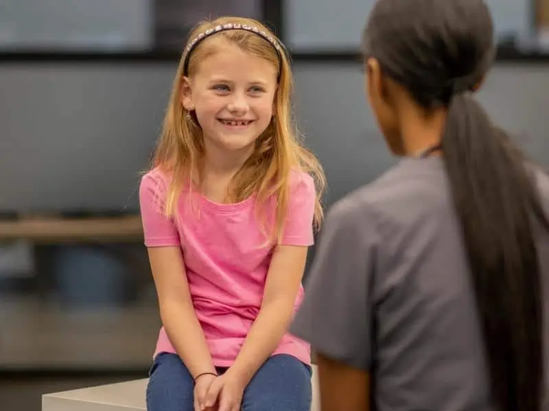 school nurse talking to a little girl