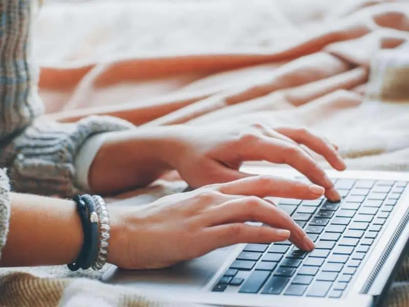 woman typing on laptop