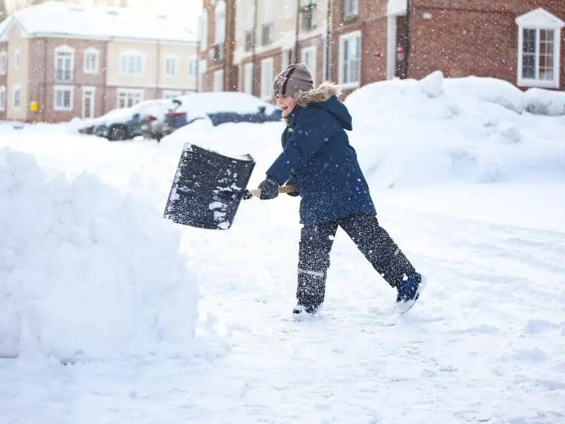 kid shoving snow