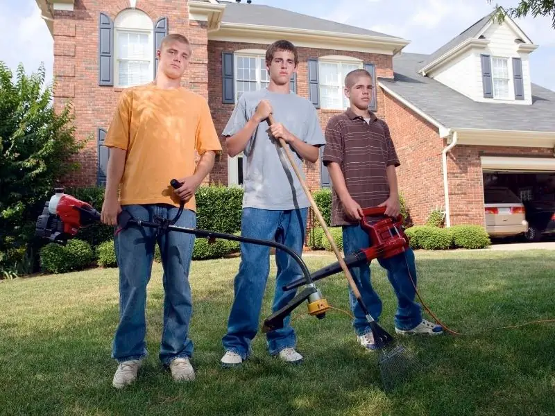 teen holding yard work tools