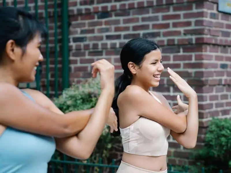 teen wearing crop top and working out