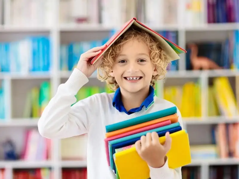 kid holding books
