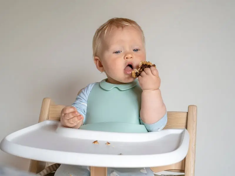 baby eating using hands