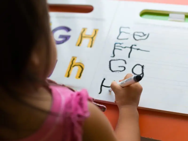 kid writing abc letters