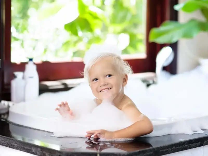 kid in a tub with shower